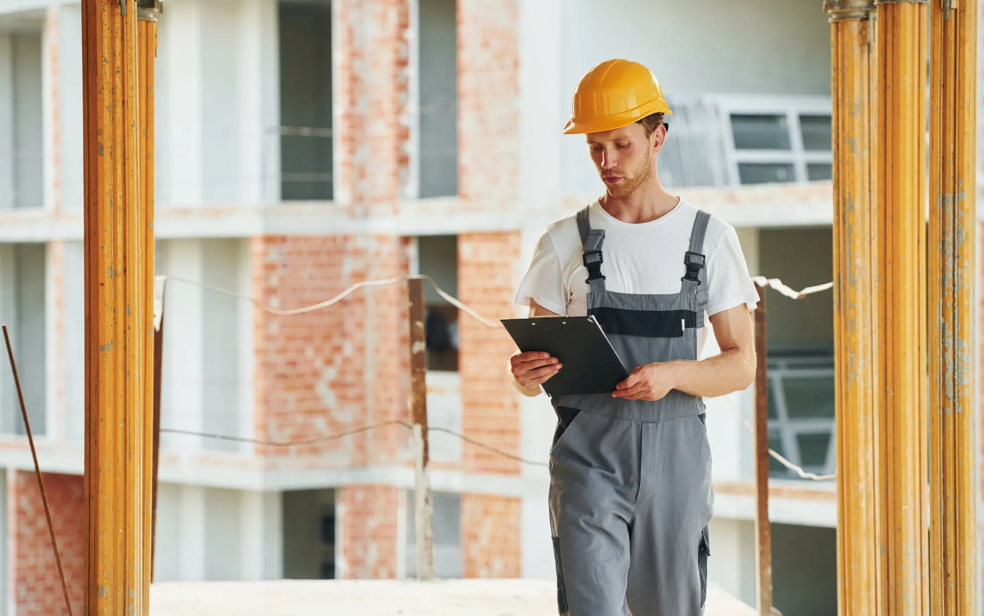 Interior house painting service with a young man working in a uniform.