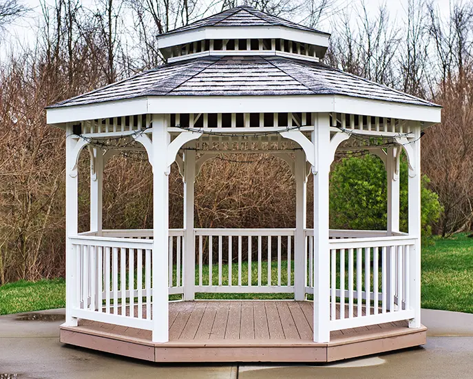 White wooden gazebo in a backyard as part of a home addition project.