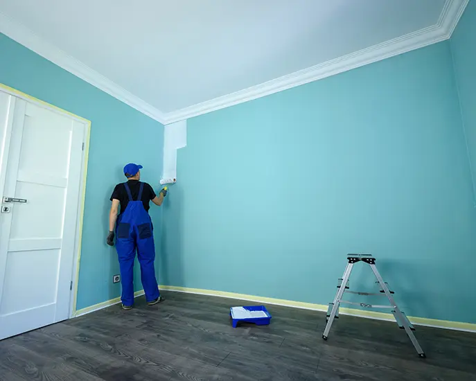 Professional painter applying a fresh coat of paint to a residential wall